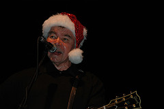 John Prine dons a Santa Cap - Photo by Capn Madd Matt